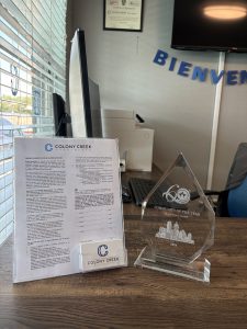 a plaque and a sign on a desk at The Colony Creek Apartments